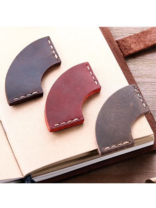 Rounded corner leather bookmarks in assorted colors stitched into journal pages