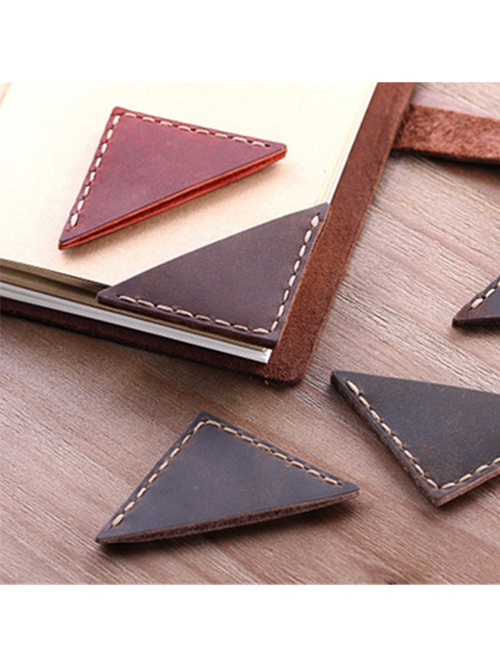 Triangle leather bookmarks in coffee, brown, and red on rustic wood background
