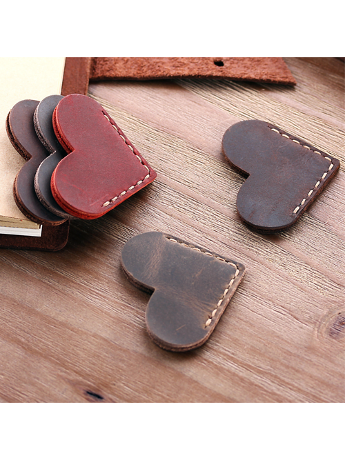 Heart-shaped Italian leather corner bookmarks in brown, red, and coffee on wooden desk